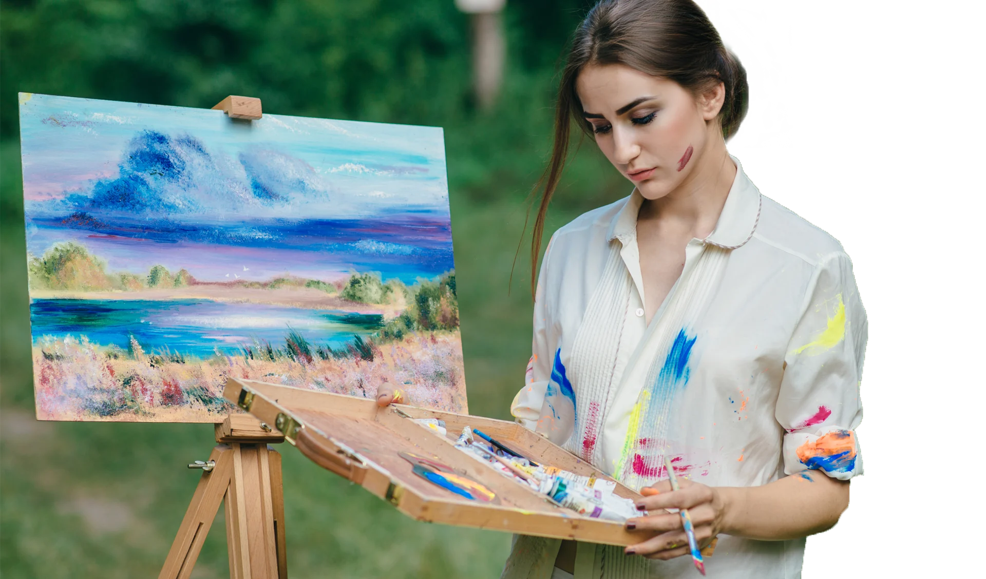 An artist painting a seascape on an easel in a garden