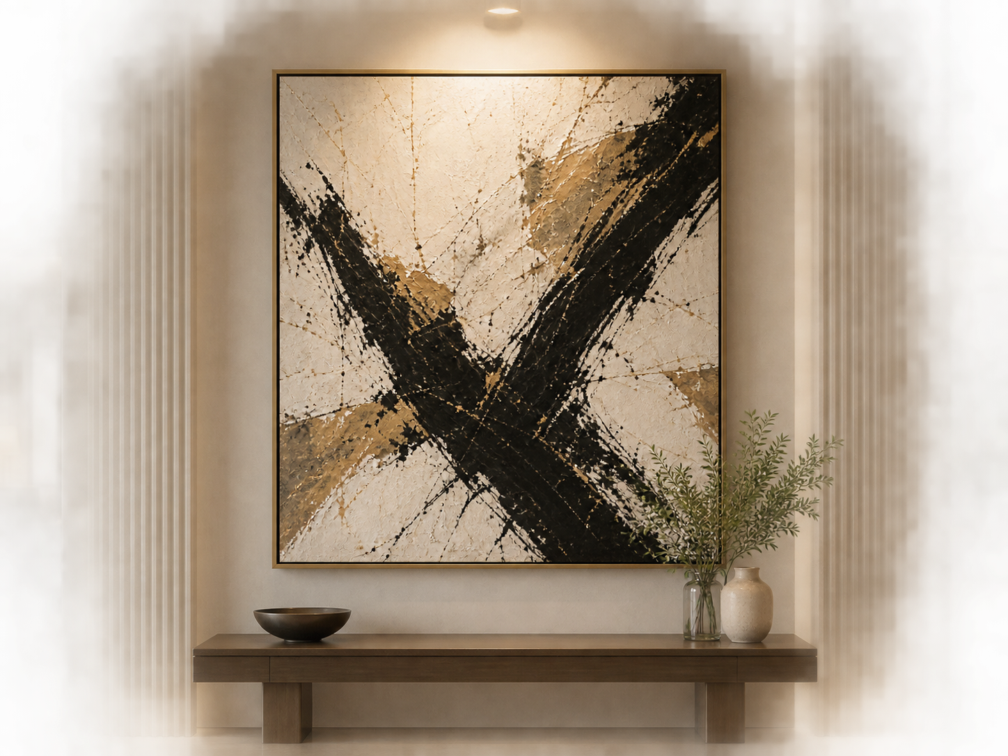 Console table styled with a lamp, ceramic bowl and stacked books beneath a framed abstract artwork